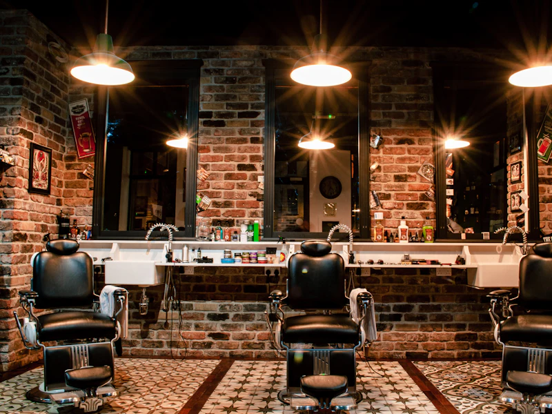 Barbershop interior with brick walls and three chairs