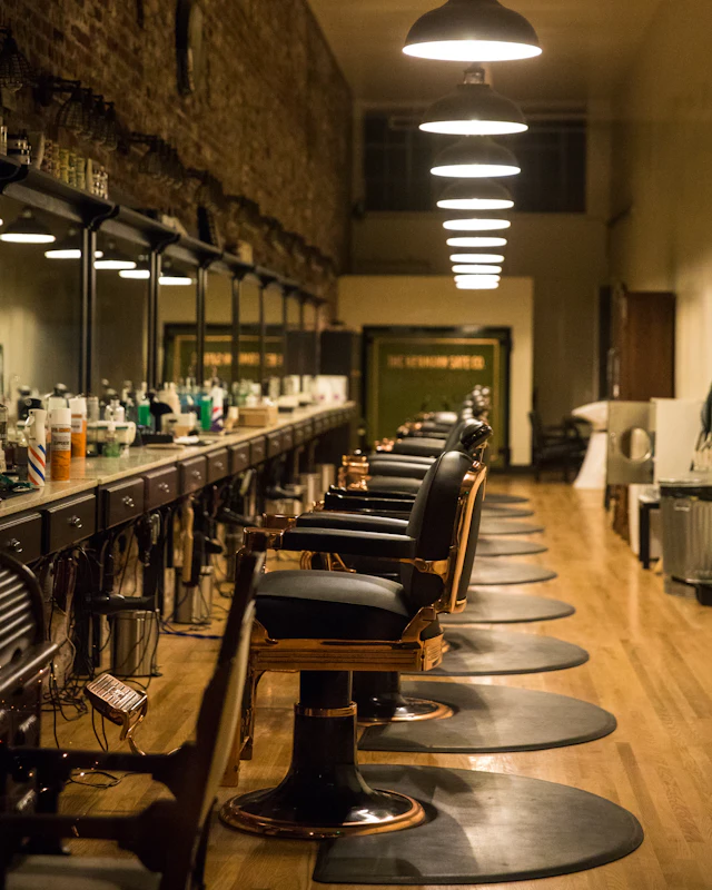 Row of classic barber chairs under warm pendant lights